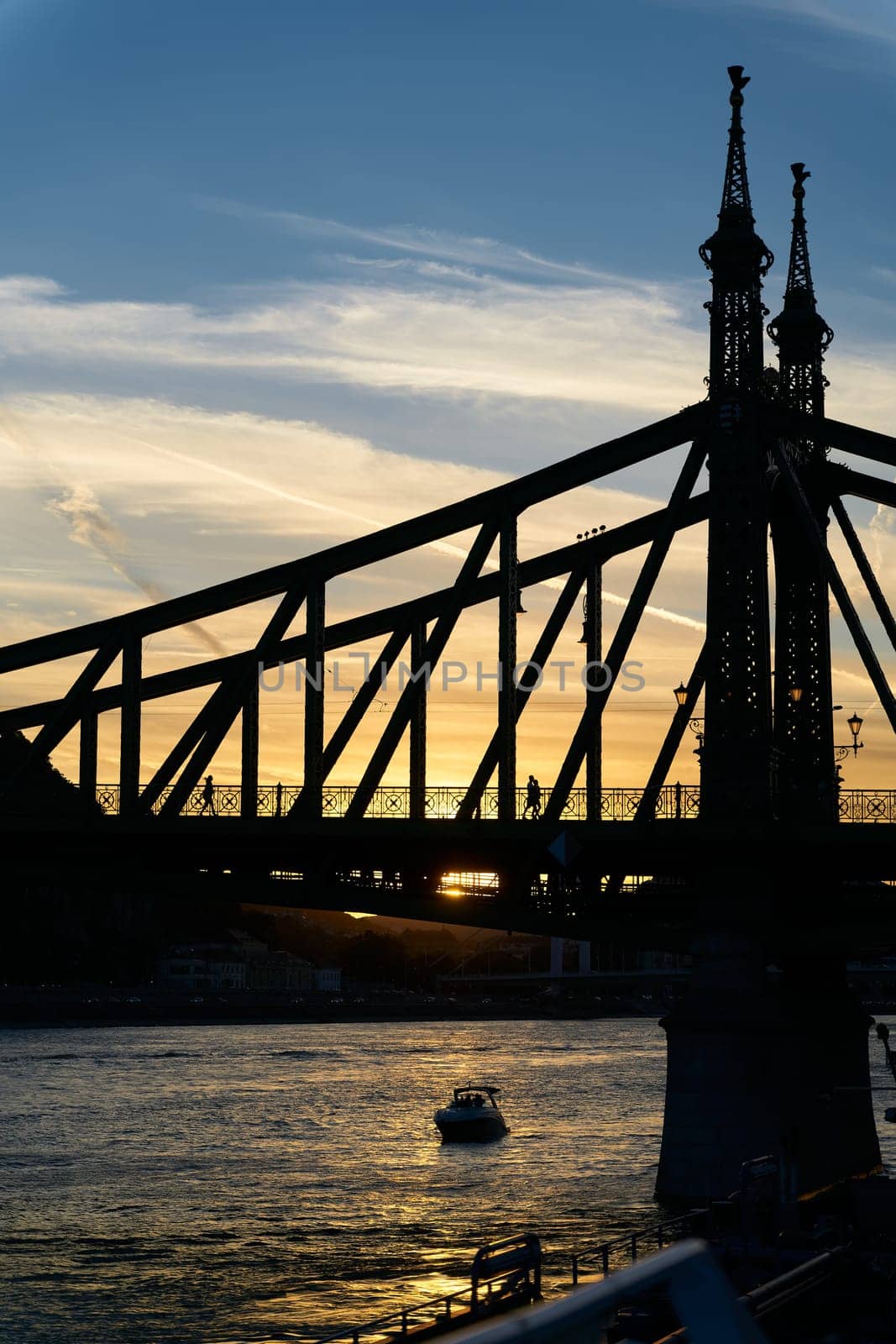 The historic Freedom Bridge over the Danube River, Szabadsag hid, in Budapest at sunset