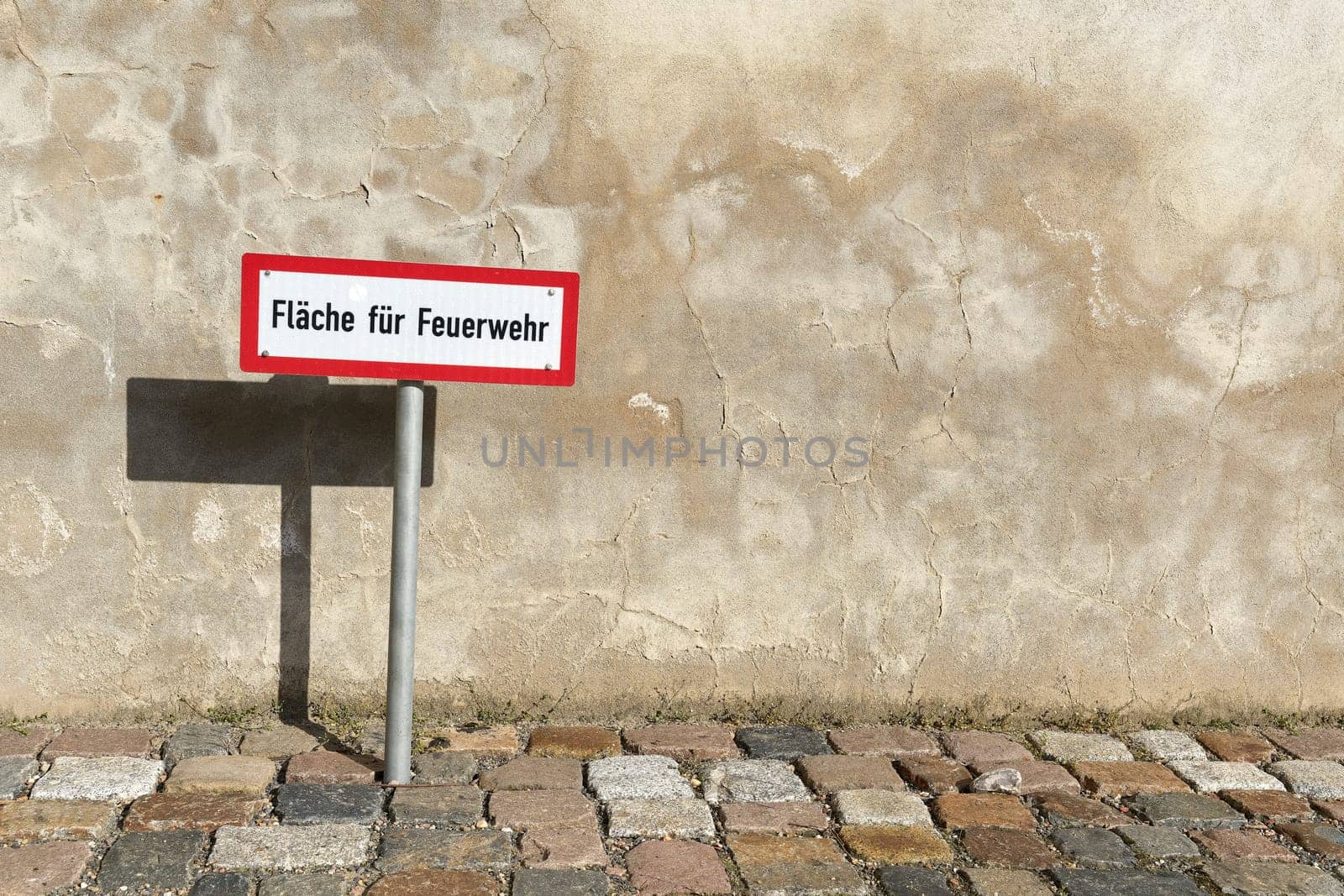 Sign at an access road for the fire department in the city center of Wittenberg in Germany. Translation: area for the fire brigade