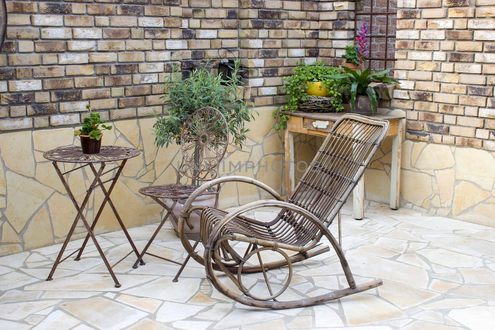 beautiful place in the garden in the mediterranean style, pots with plants, table with chairs