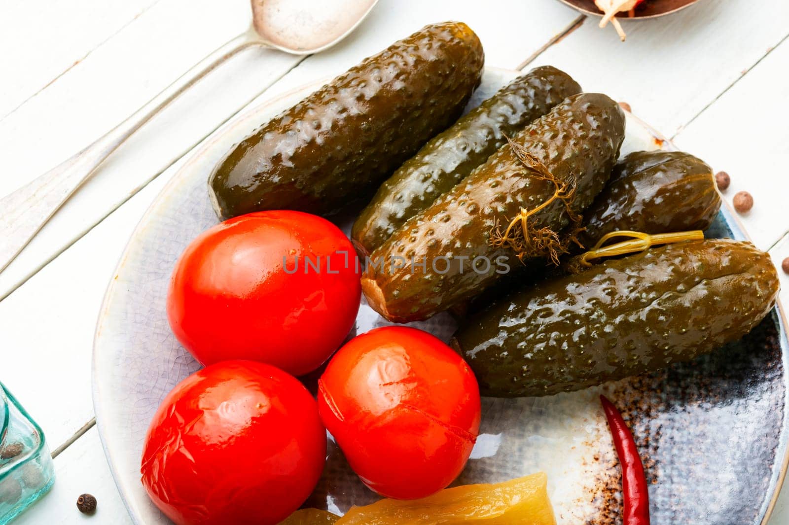 Homemade pickled cucumbers and tomatoes, homemade pickles. White background