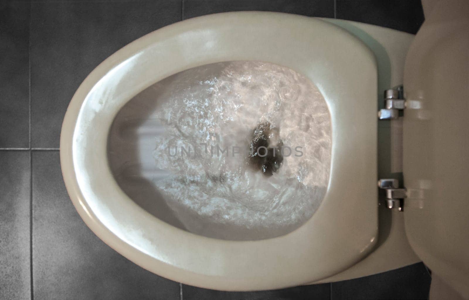 Old regular toilet flushing excessive use of water. Low-efficiency toilets