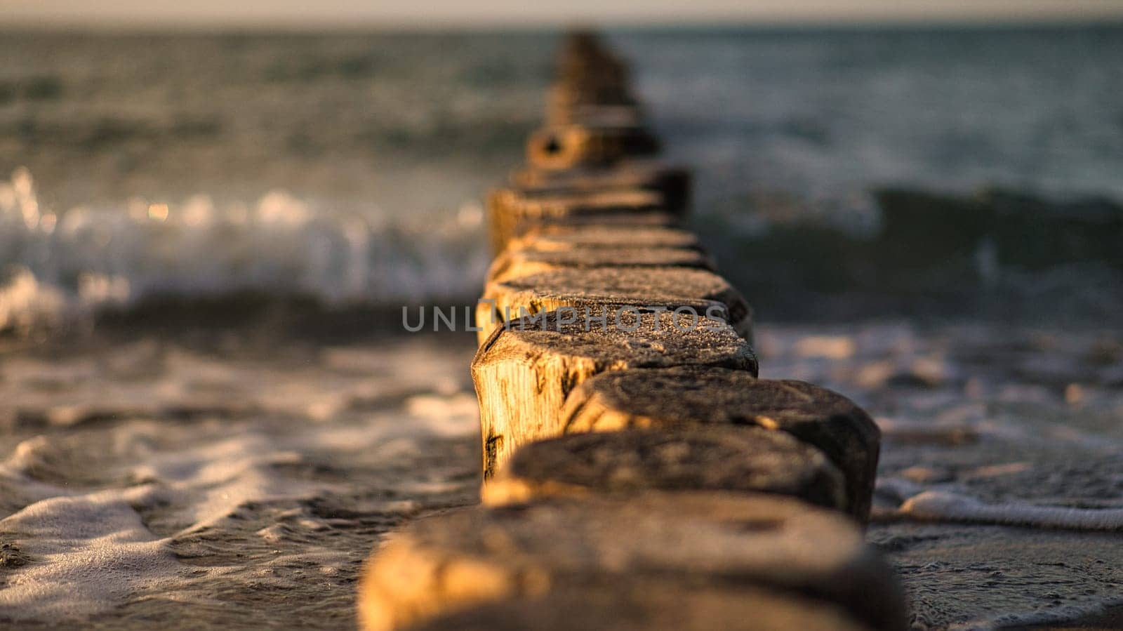 the Baltic Sea through the sea to the horizon at sunset. Romantic mood on vacation in Zingst