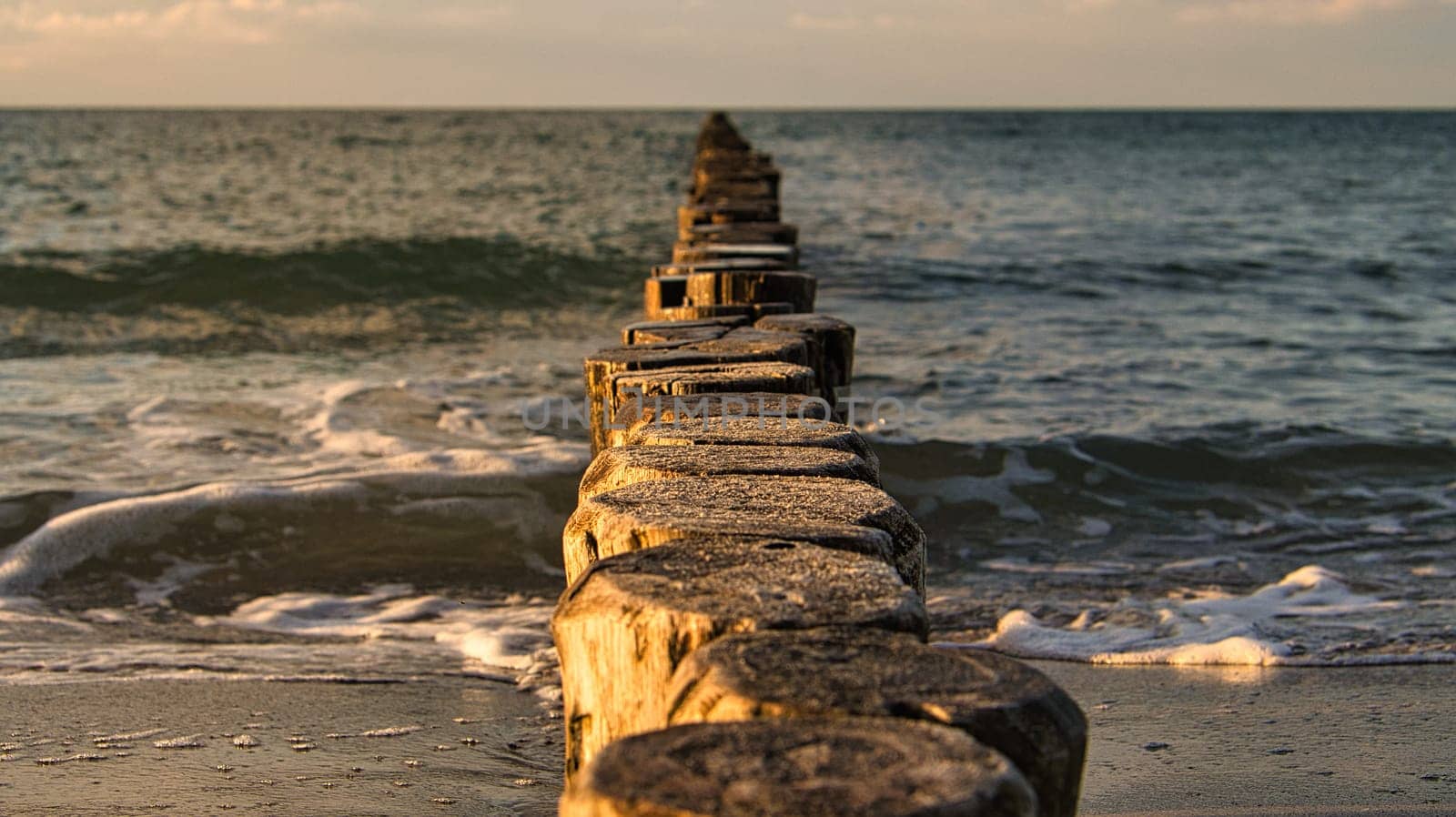 the Baltic Sea through the sea to the horizon at sunset. Romantic mood on vacation in Zingst
