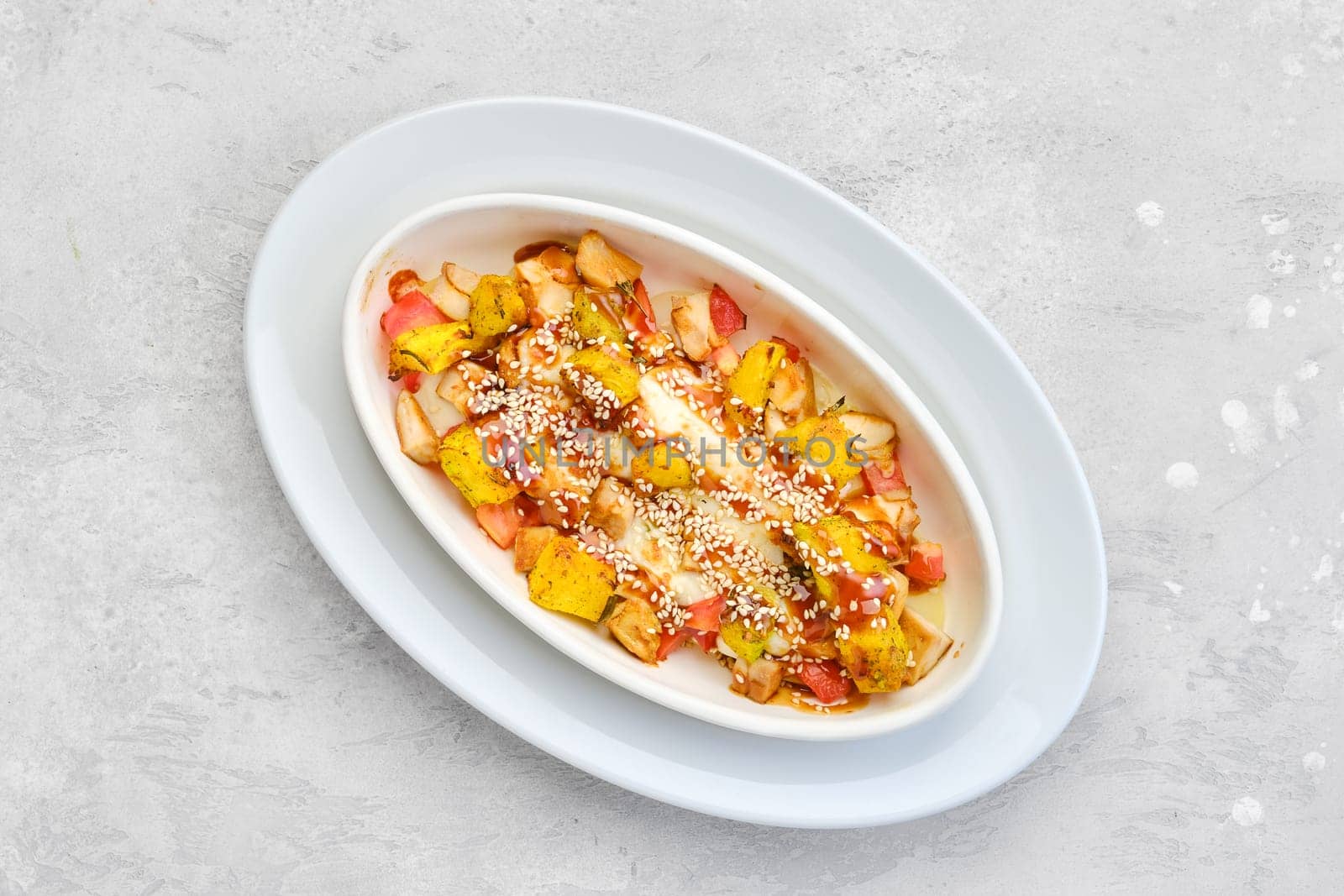 Overhead view of hot casserole with chicken, pumpkin, bell pepper and potatoes