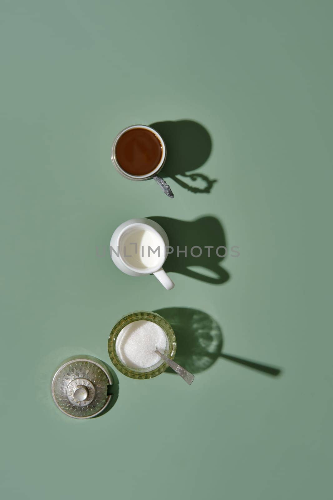 Coffee concept - overhead view of cup of coffee, geyser coffee maker and shugar