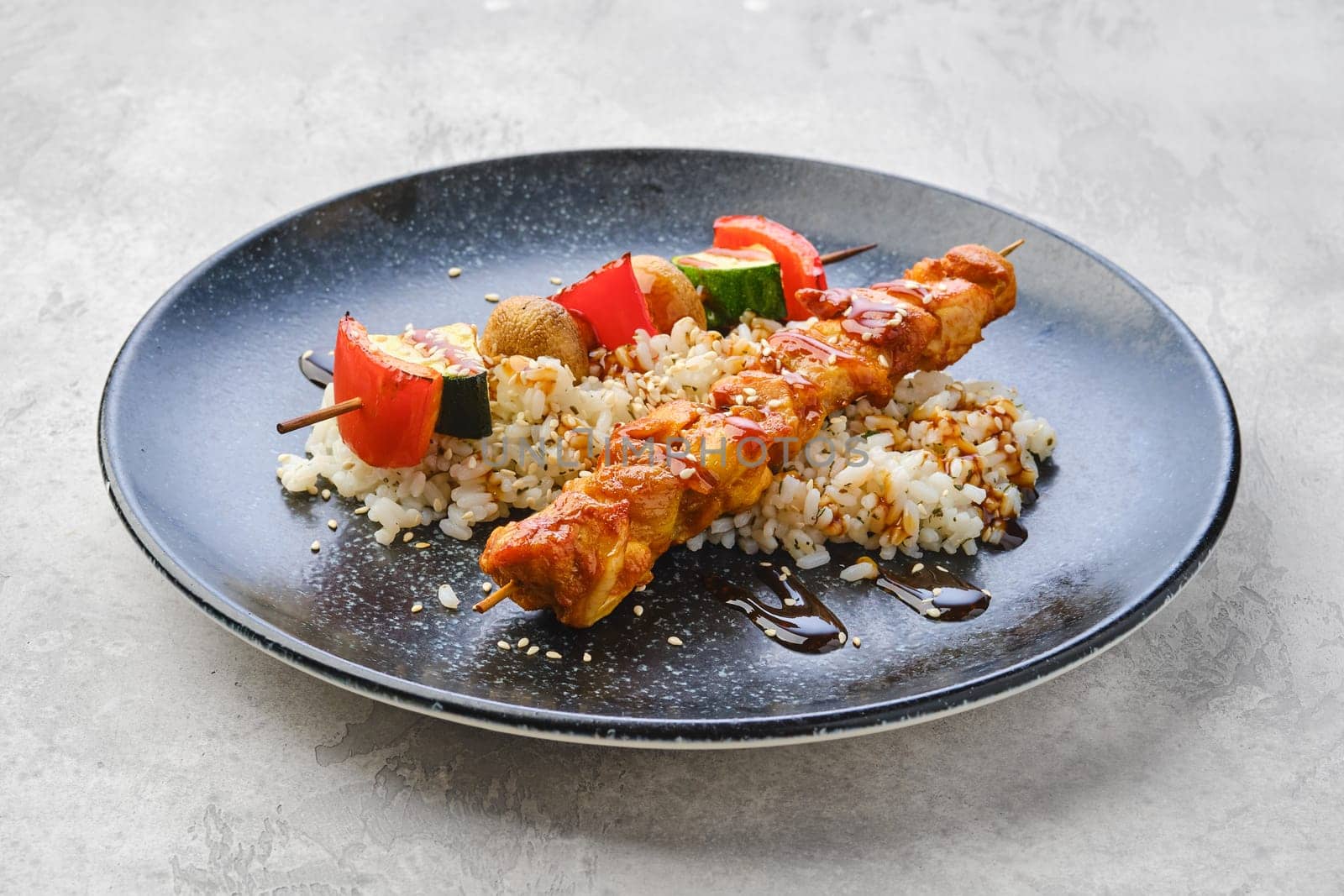 Shashlik with chicken and grilled champignon with bell pepper and zucchini served with boiled rice