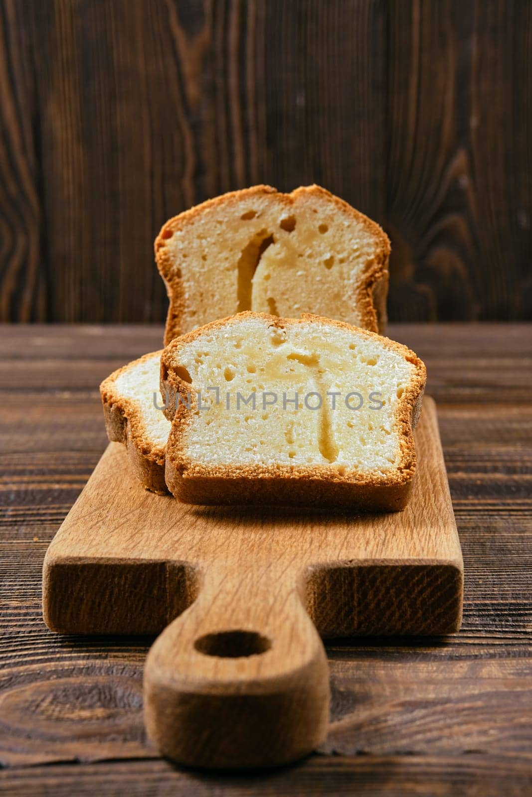 Closeup view of fresh biscuit cake with apple on wooden table