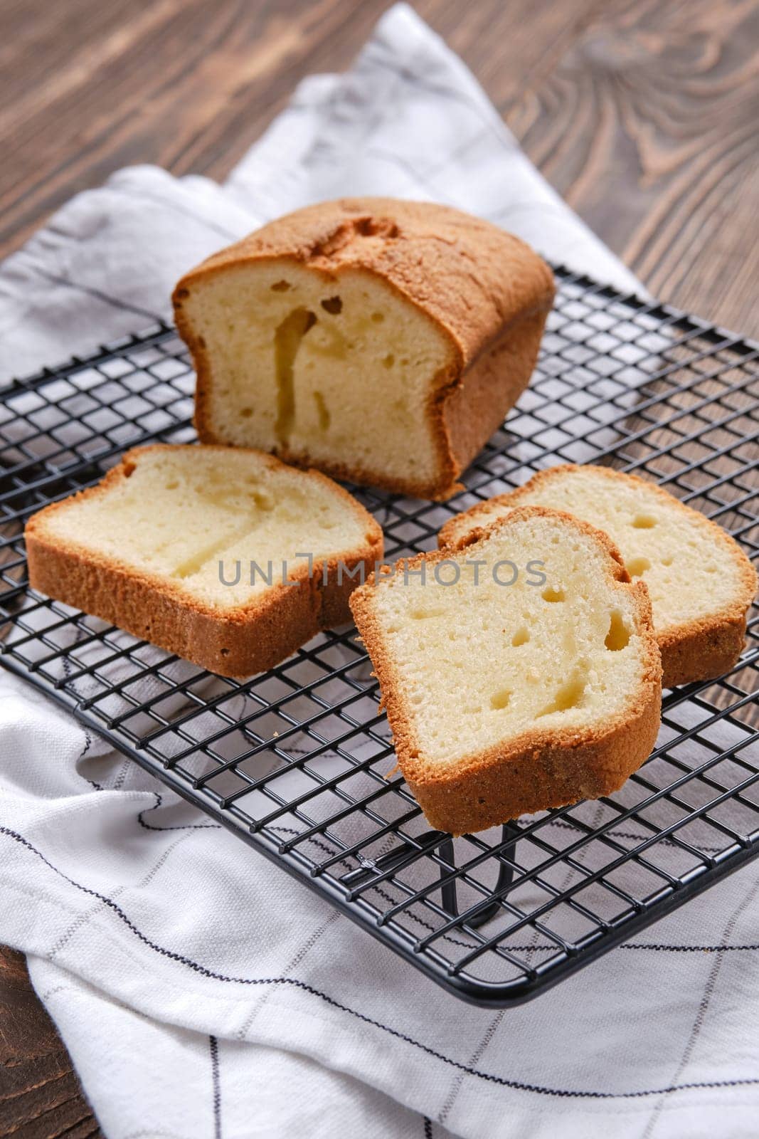 Closeup view of fresh biscuit cake with apple on wooden table