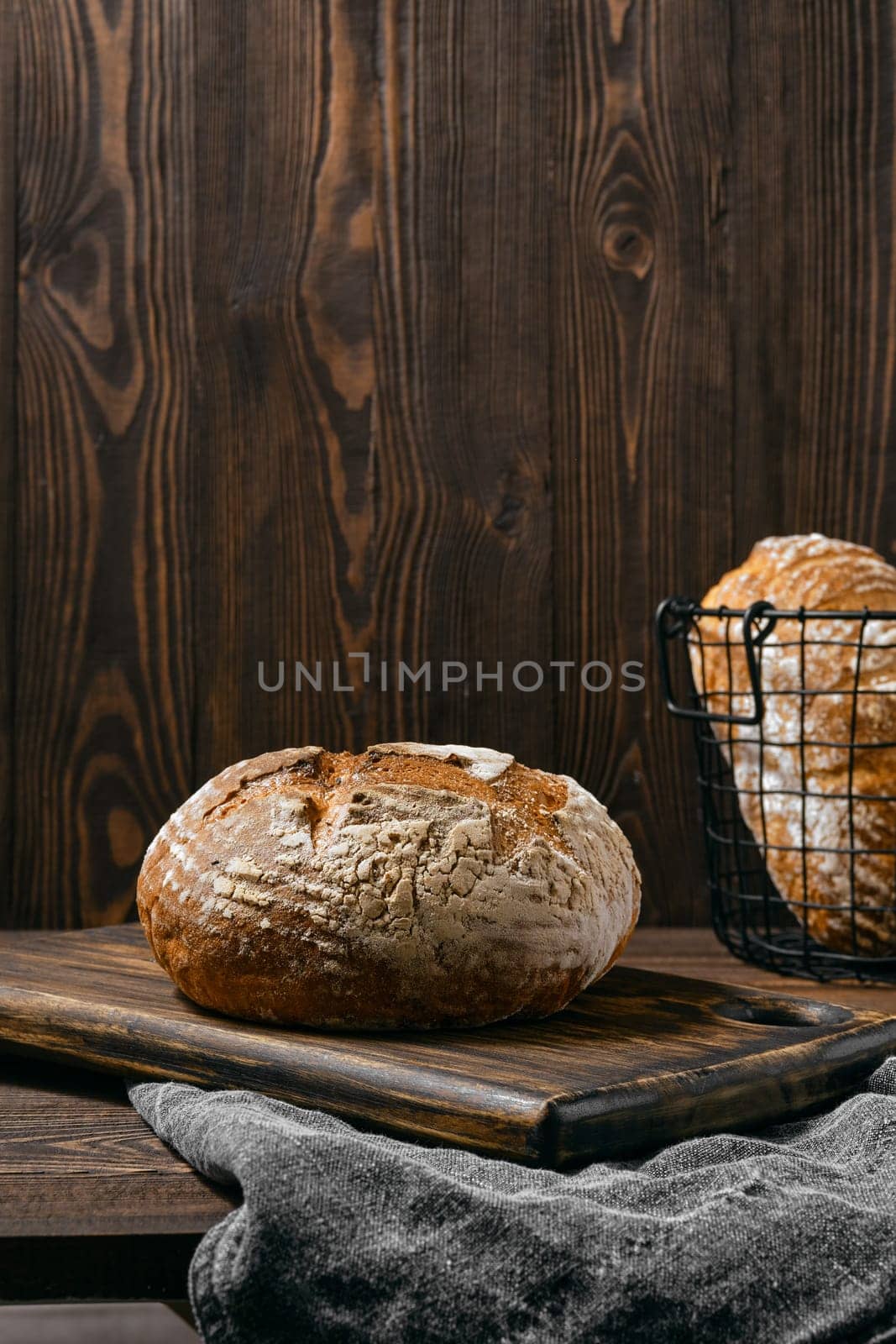 Artisan whole grain tomato wheat bread on wooden table
