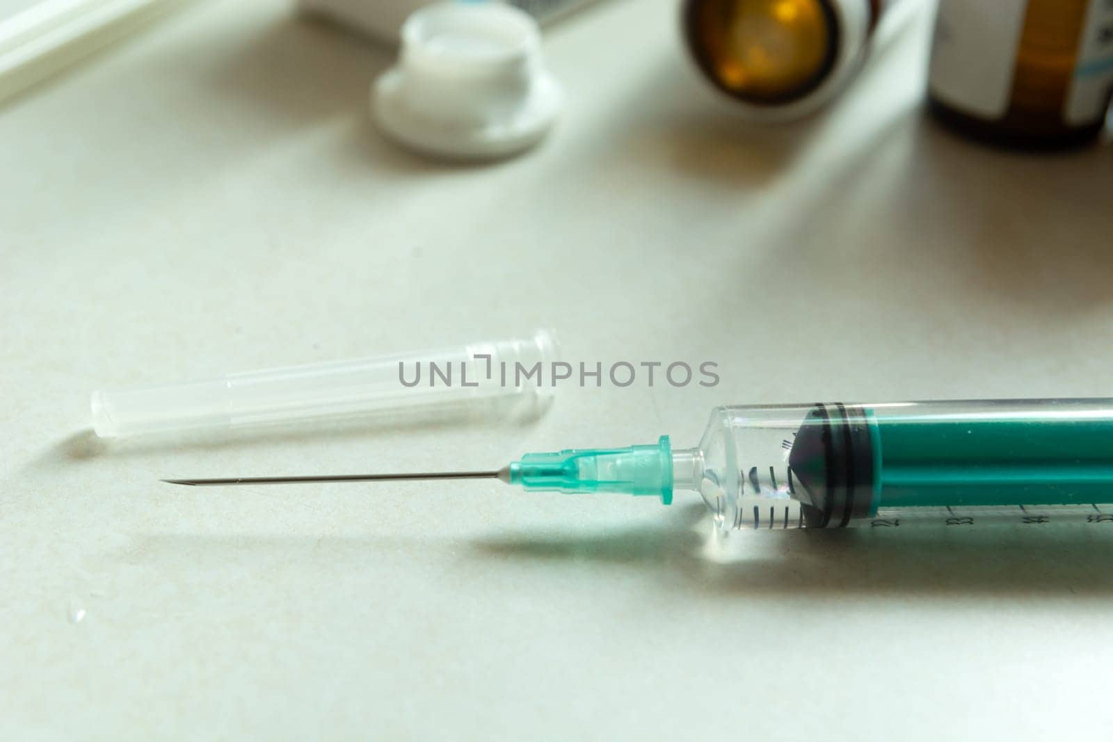 Closeup of a syringe with a long needle on the countertop