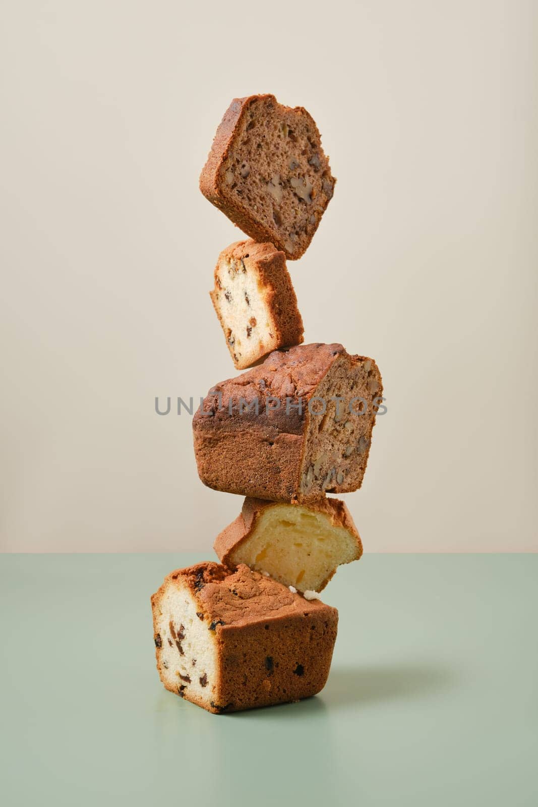 Stacked pieces of biscuit cupcakes. Balancing cakes.