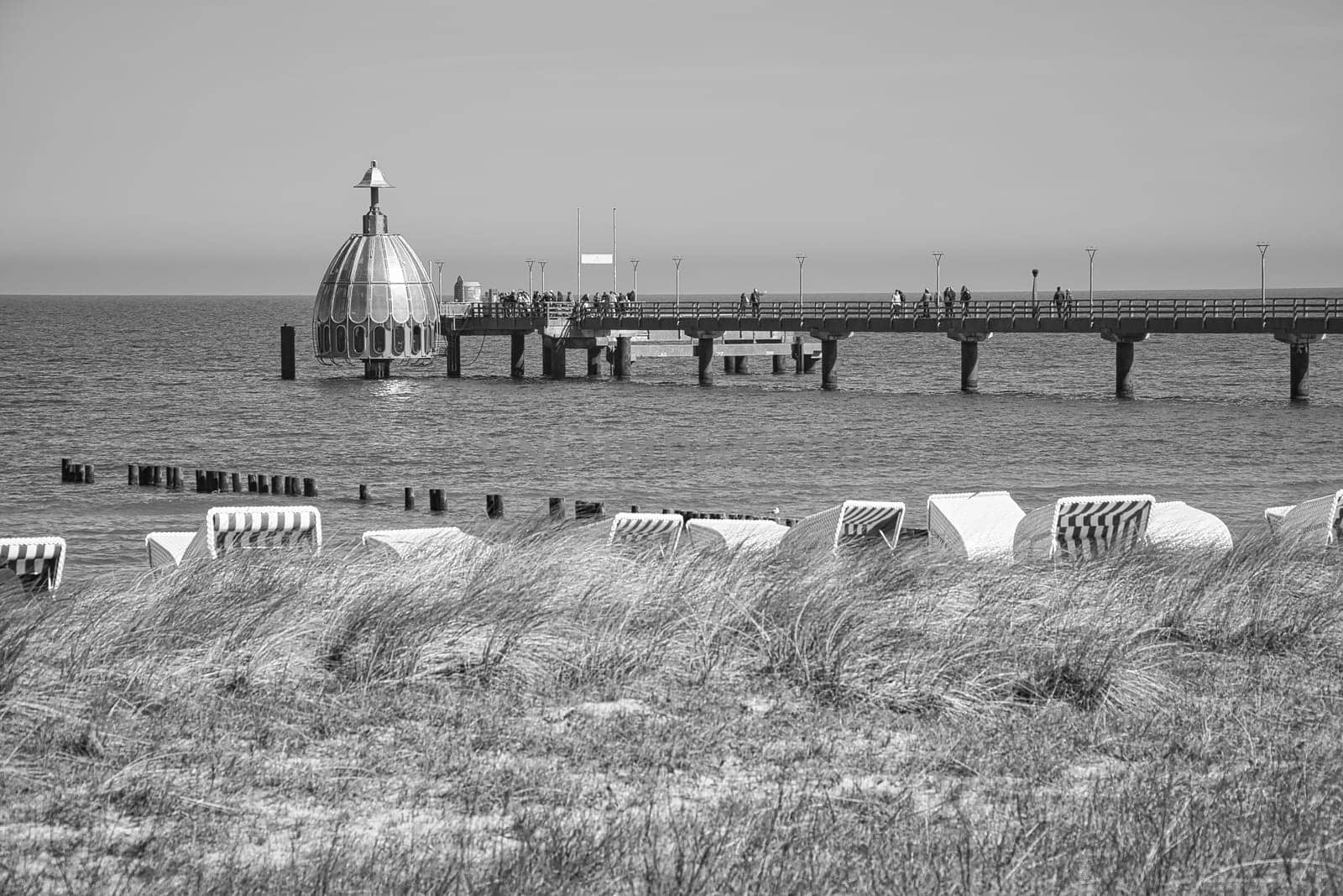 on the coast of the baltic sea on zingst. the pier and the groynes that reach into the water. beautiful light atmosphere in a romantic place