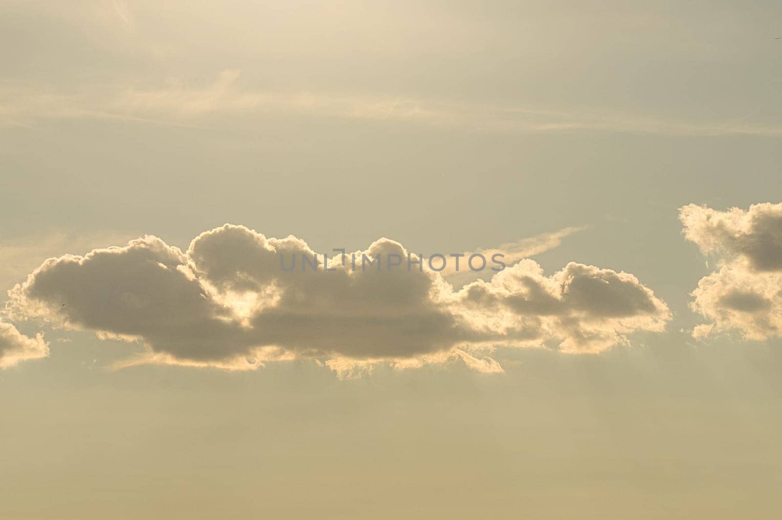 Clouds illuminated by the sun in the sky as background. Background image for further editing