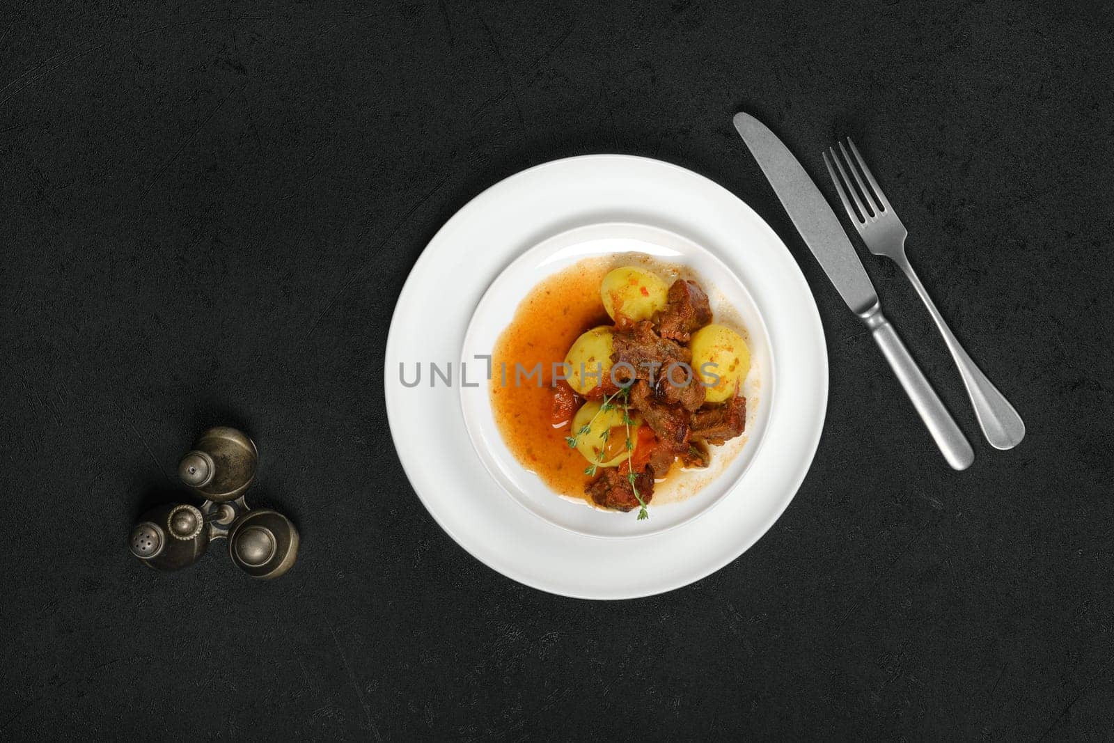 Overhead view of lamb stew with potato on a plate