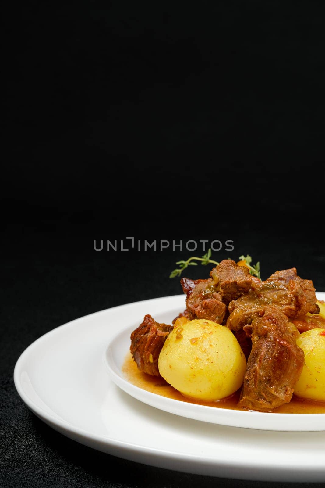 Closeup view of lamb stew with potato on a plate