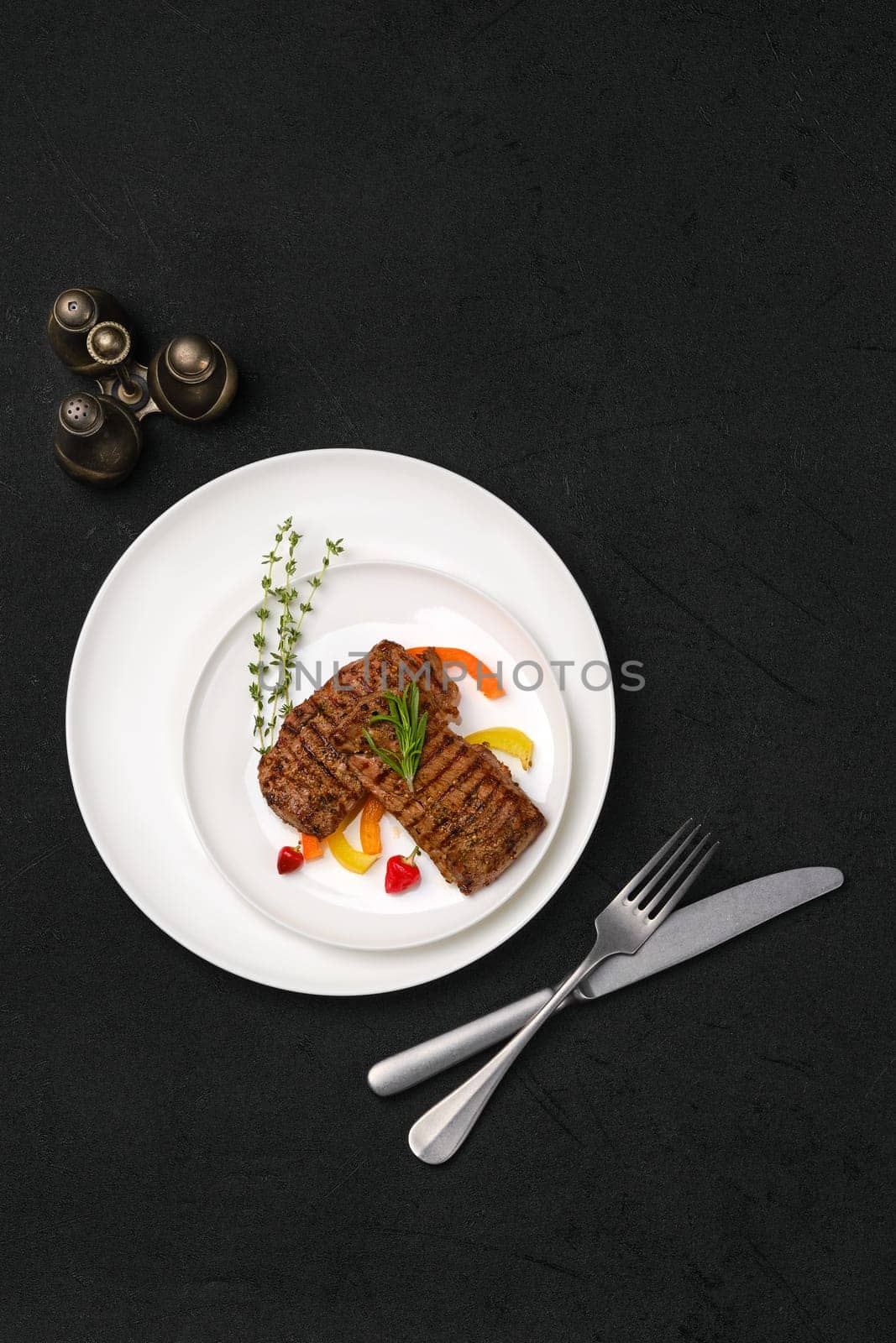 Top view of two grilled steaks on a plate