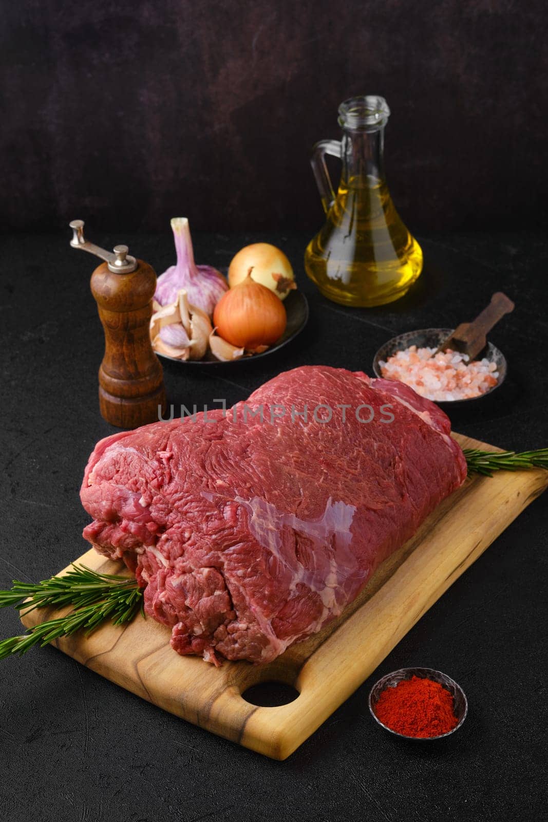 Overhead view of raw chuck eye roast with ingredients for cooking