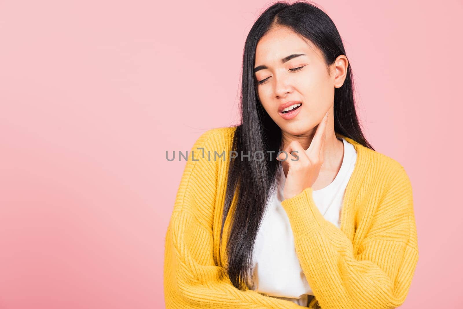 Portrait of Asian beautiful young woman has chin pain, female painful use finger touching itching his chin, studio shot isolated on pink background, Health and medical problem and Dental care concept