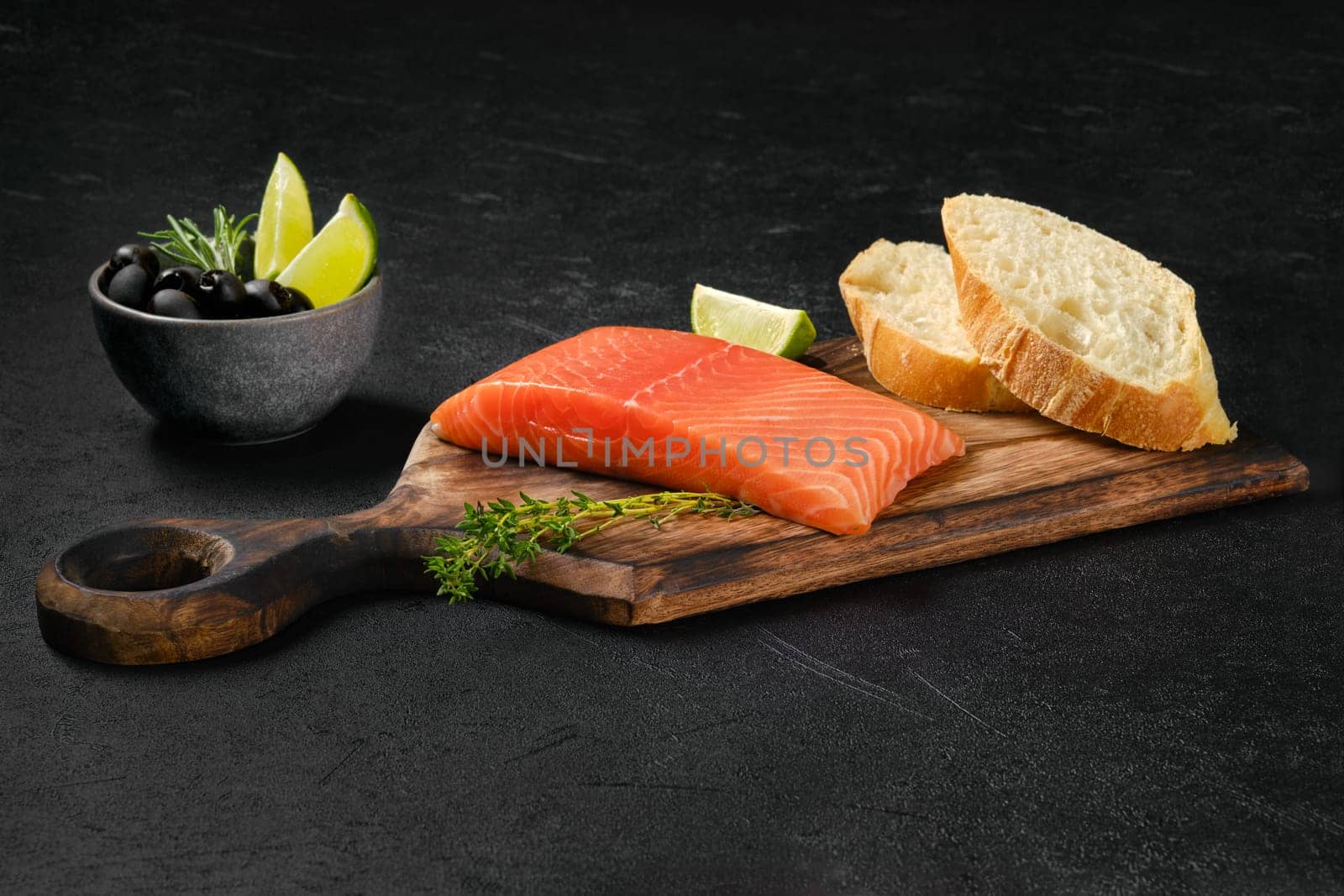 Piece of fresh salmon steak with ciabatta and spicy herb sauce