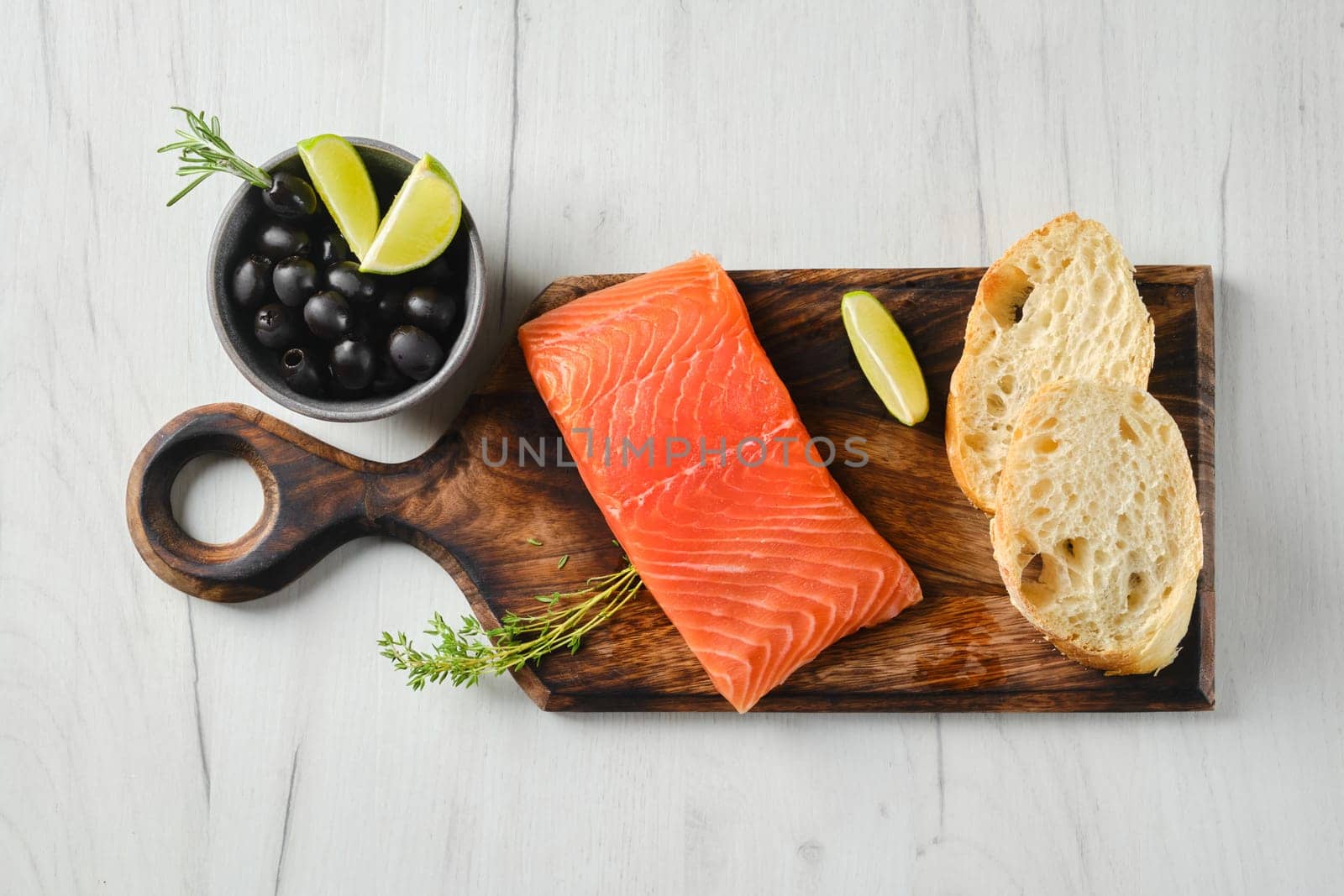Top view of piece of fresh salmon steak with ciabatta and spicy herb sauce