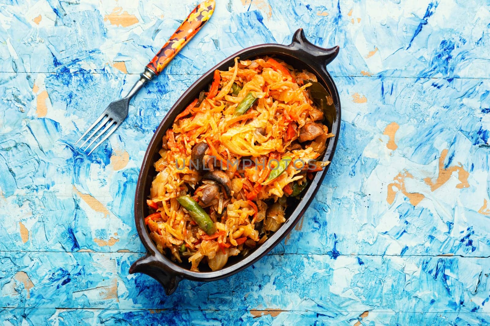 Cabbage stewed with mushrooms and carrots. Lenten food. Copy space, recipe place