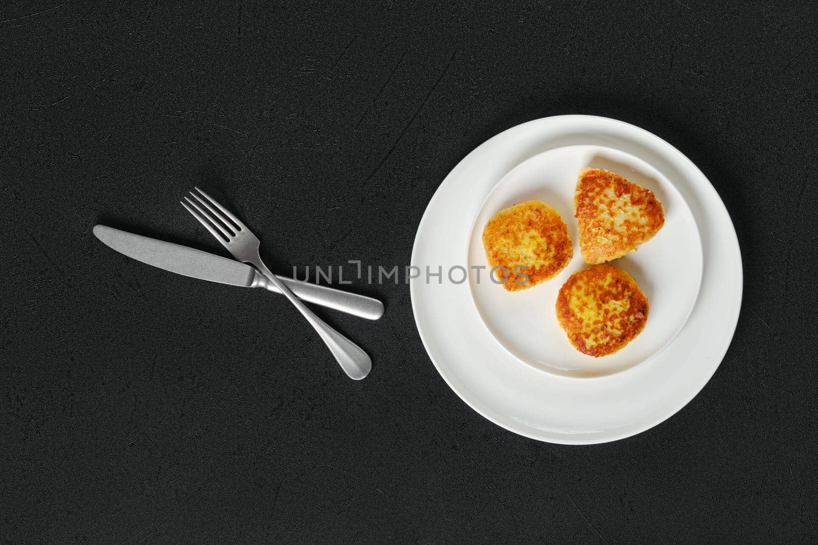 Top view of fried squid cutlet in breading on a plate