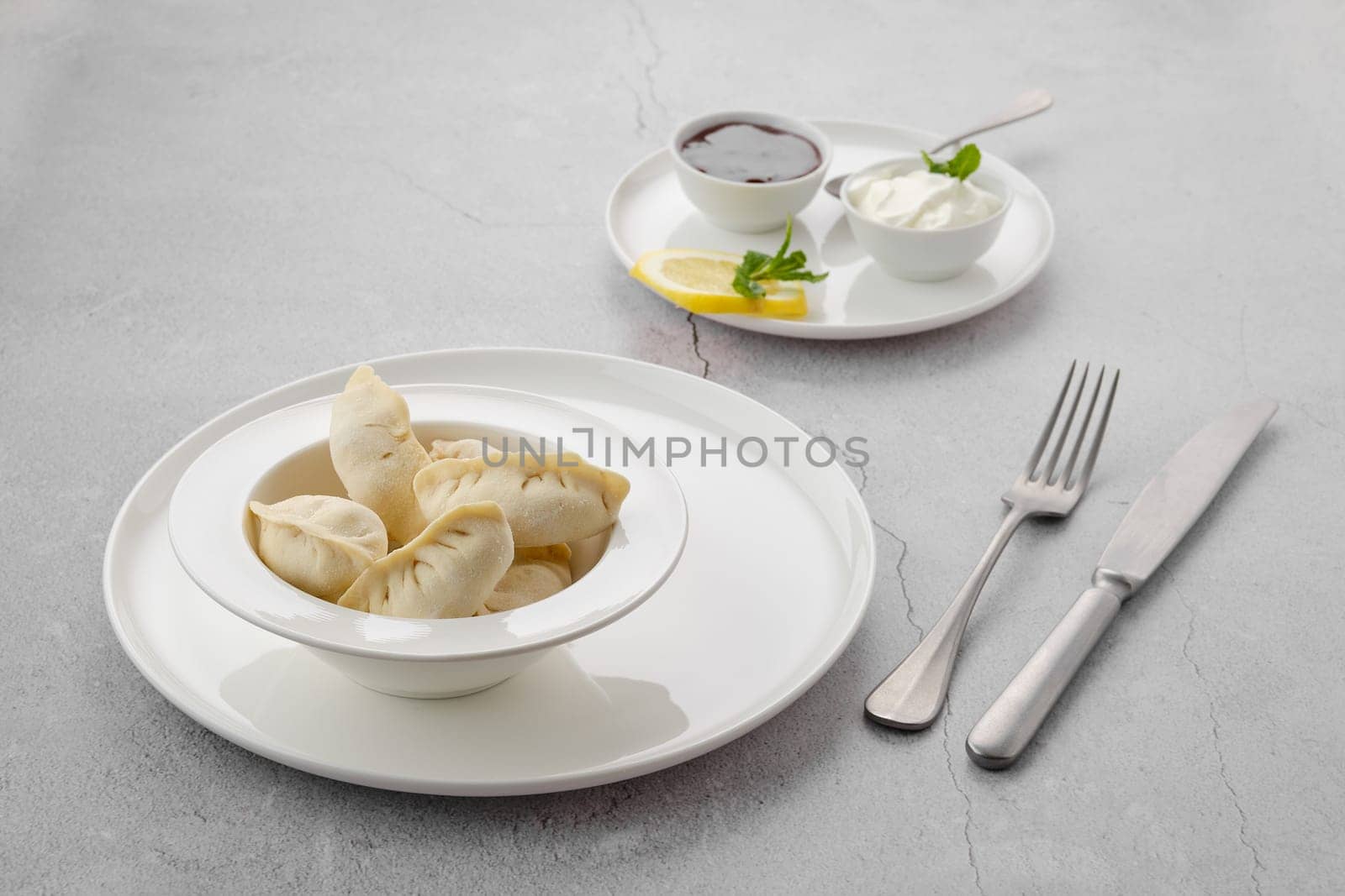 Frozen semifinished vareniki stuffed with strawberry on grey background
