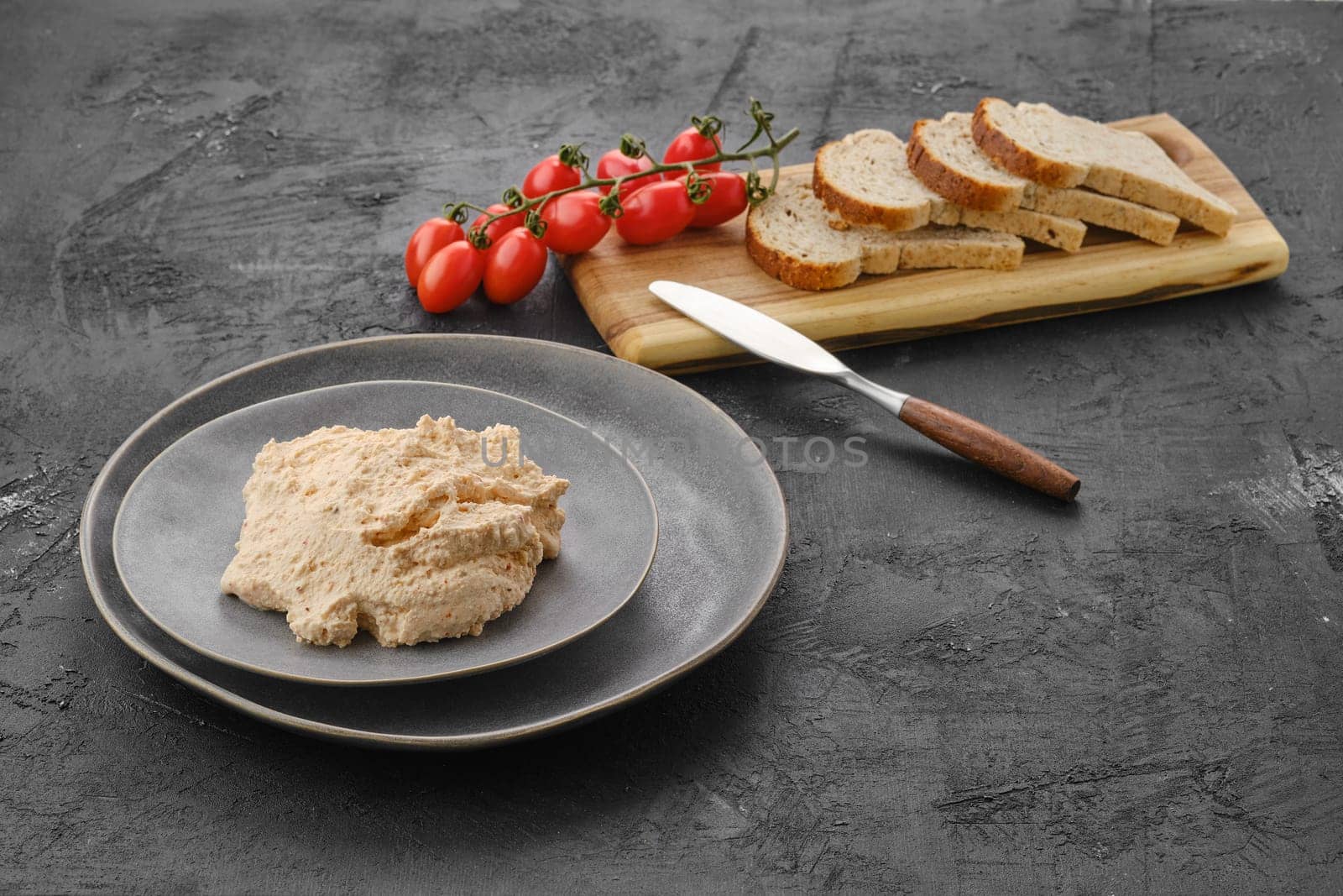 Homemade soft cheese ricotta with paprika and dill on the plate