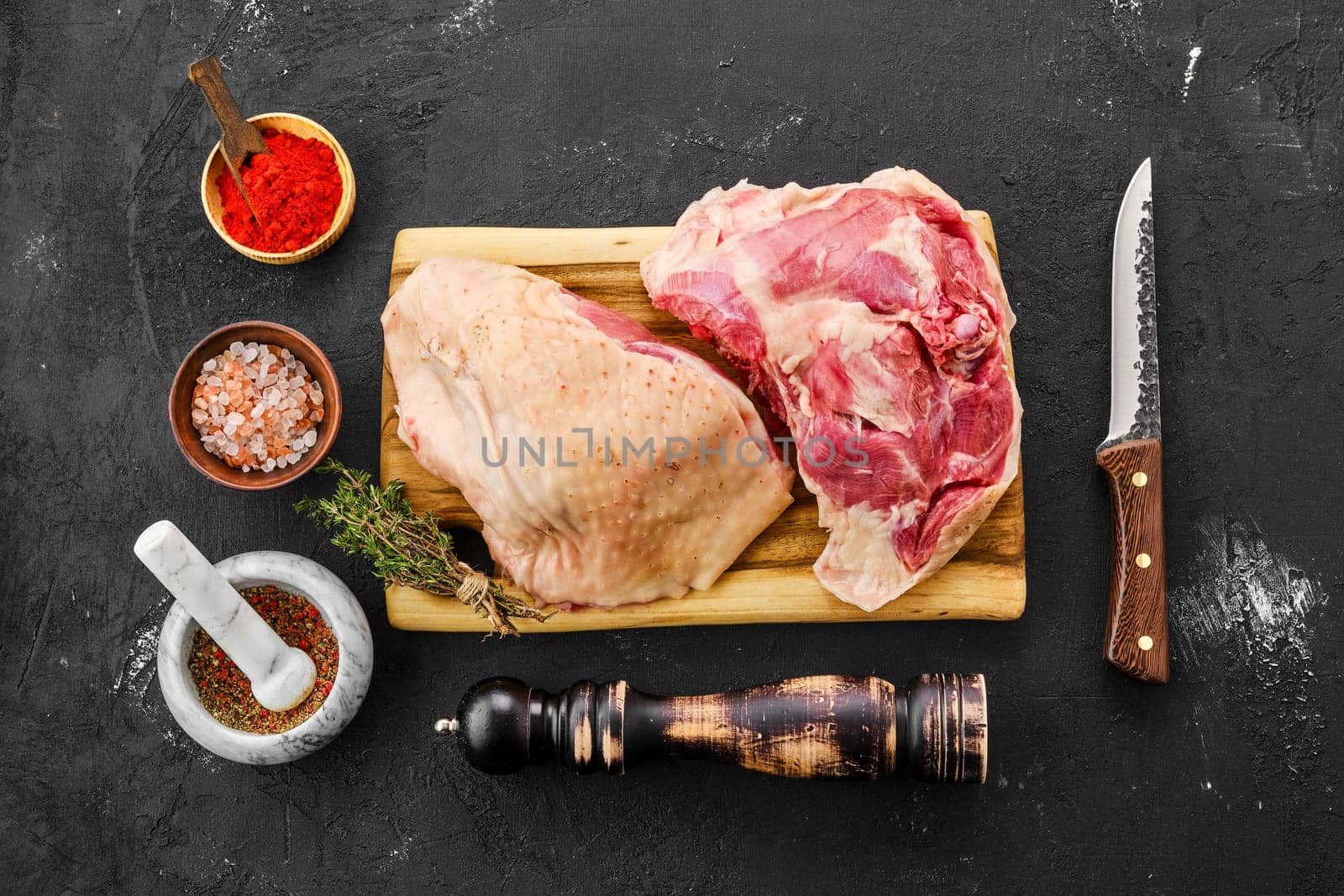Top view of raw fresh turkey thigh with spices