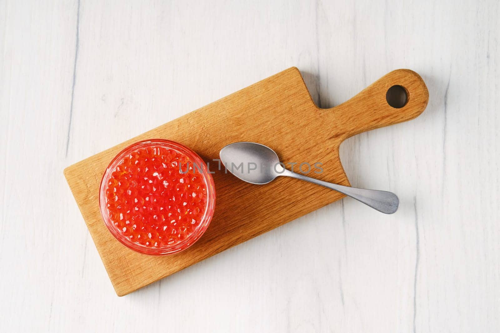 Overhead view of open pot with pink salmon red caviar