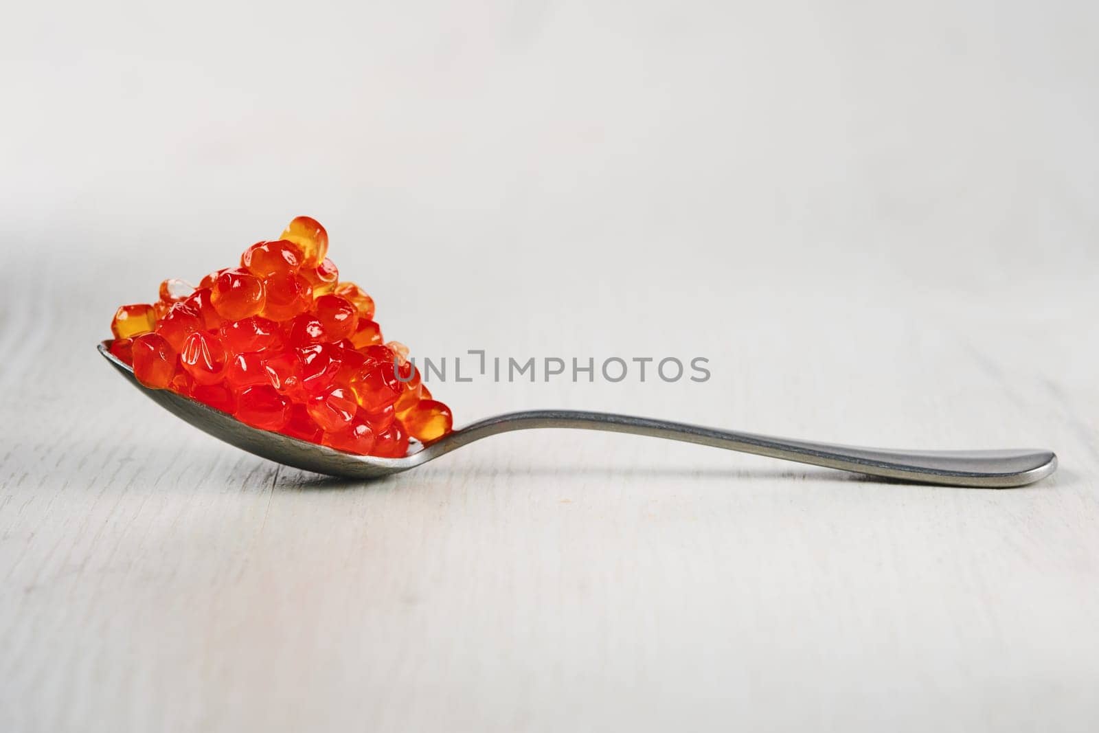 Spoon with salmon red caviar.