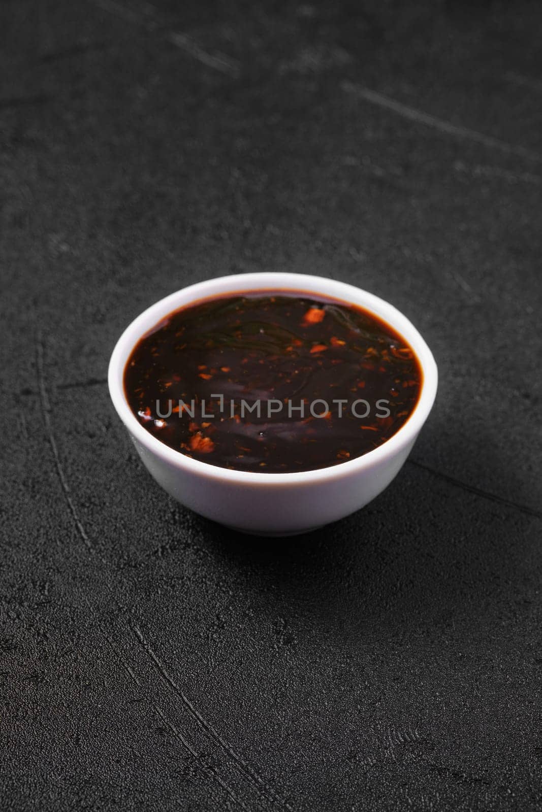 Small bowl with spicy teriyaki sauce.