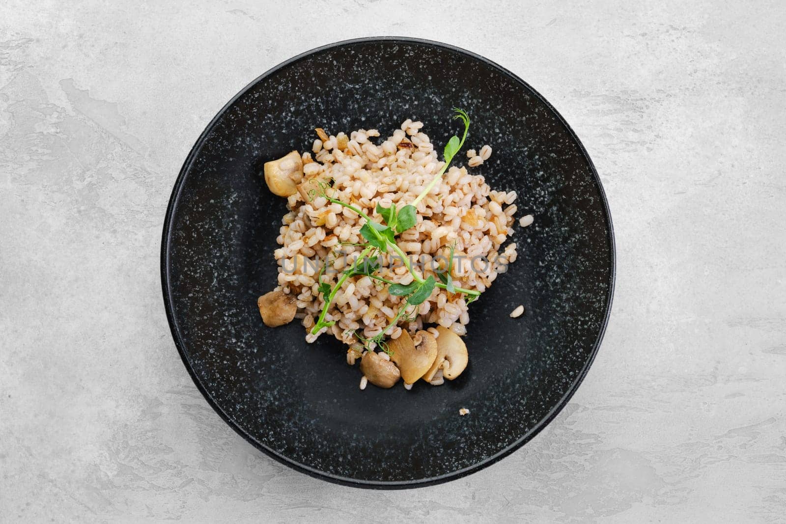 Boilet pearl barley with fried mushrooms, top view