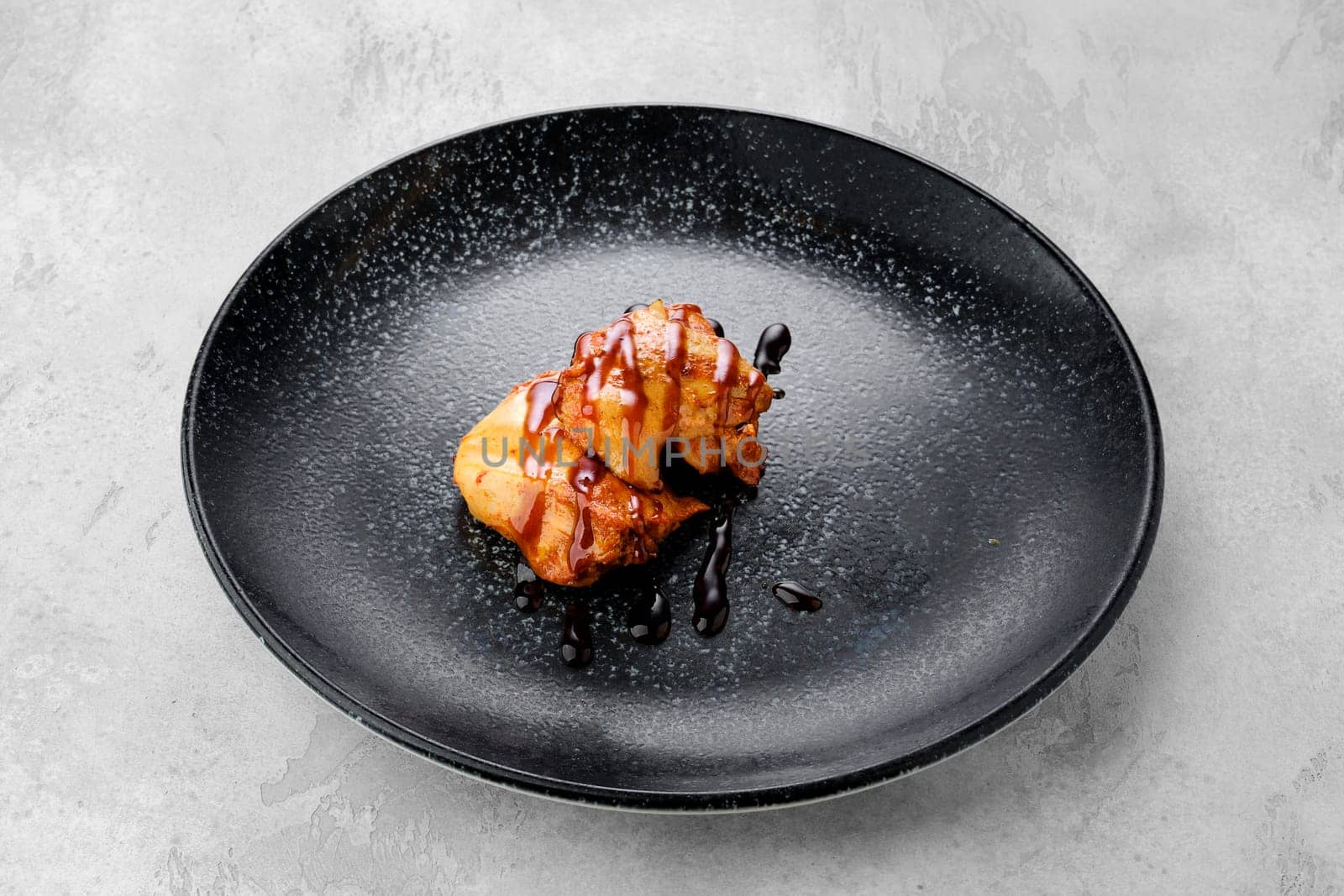 Fried chicken meat with teriyaki sauce on a plate