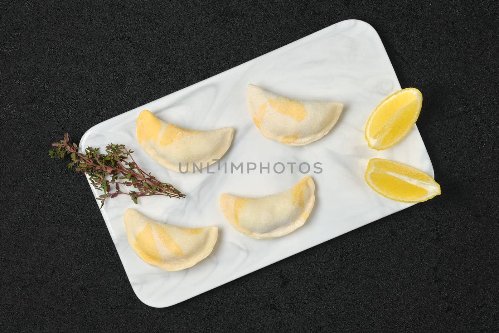 Semifinished frozen salmon dumplings on serving board, top view