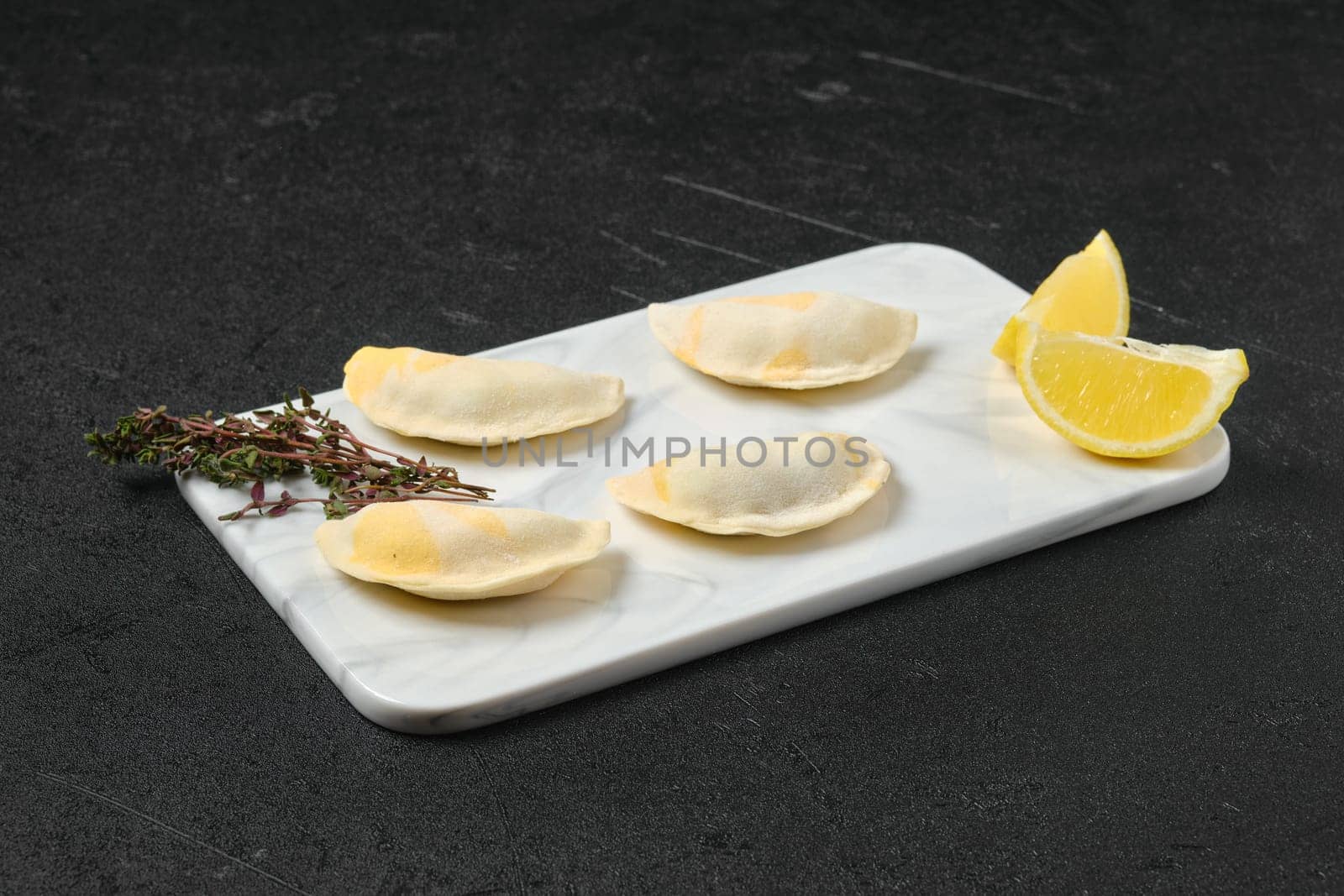 Semifinished frozen salmon dumplings on serving board