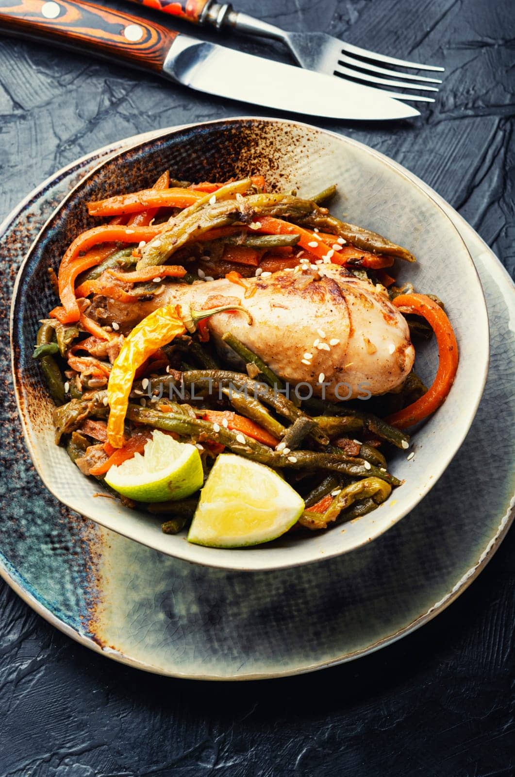 Delicious chicken legs stewed with asparagus beans and carrots.