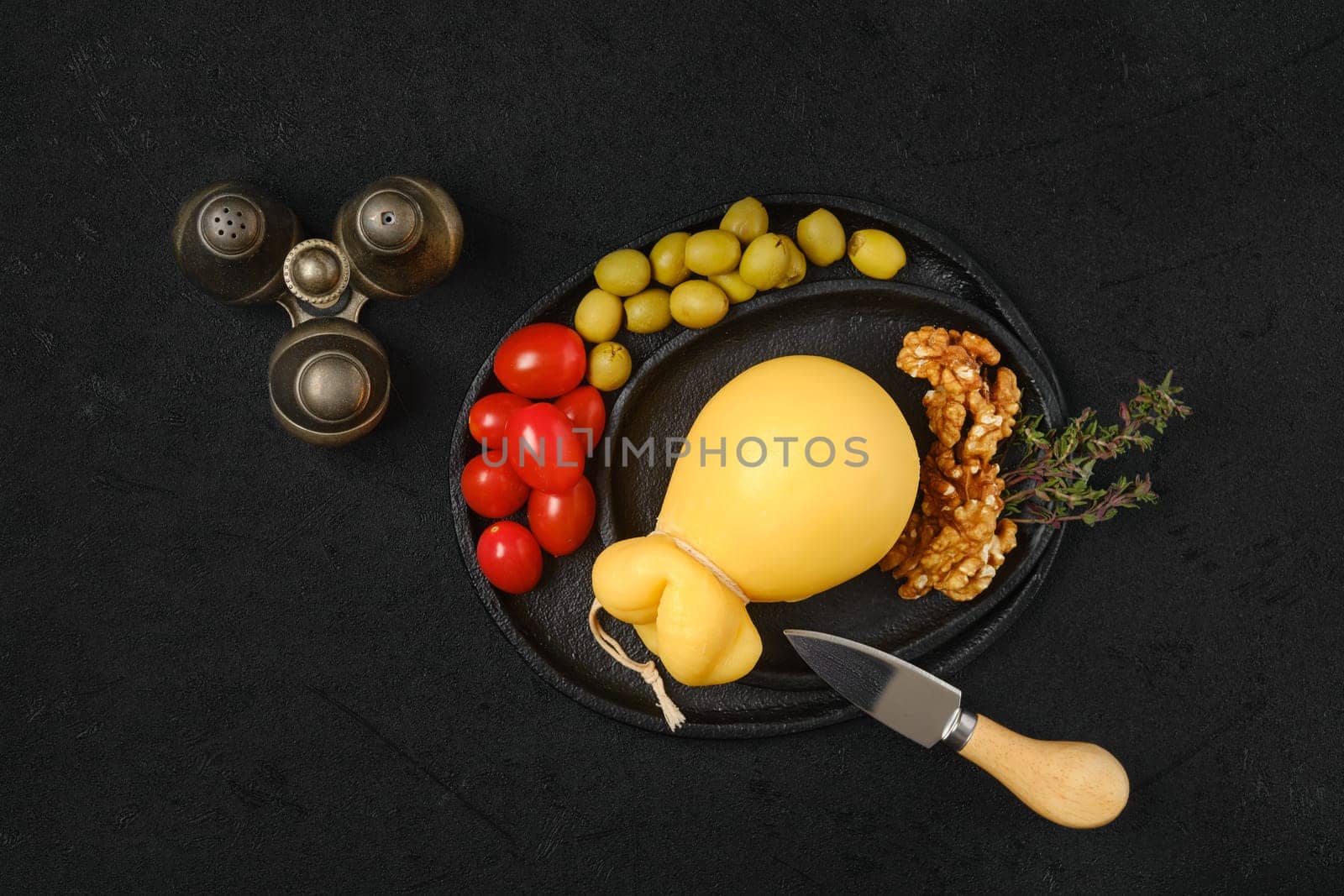 Overhead view of pulled caciocavallo yellow cheese on a plate