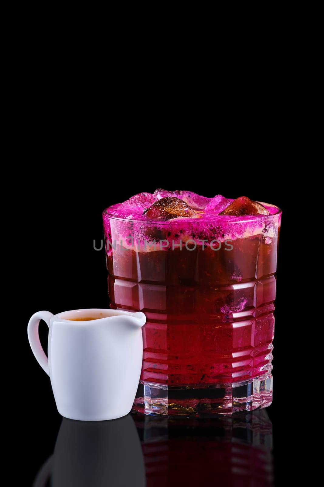 Espresso and tonic with dragon fruit isolated on black background