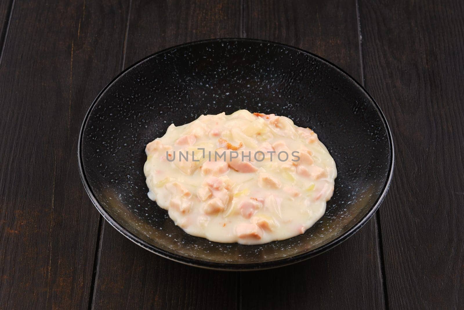 Ham and bacon with onion with creamy bechamel sauce