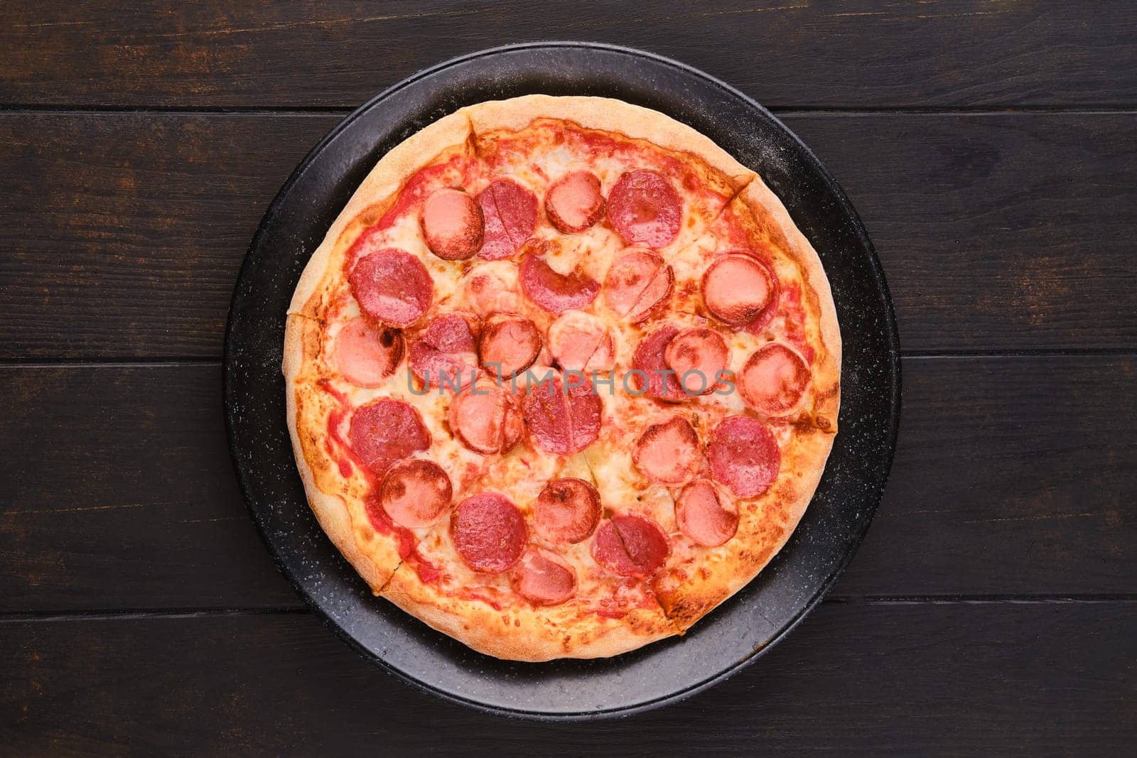 Simple pizza with sausages, top view