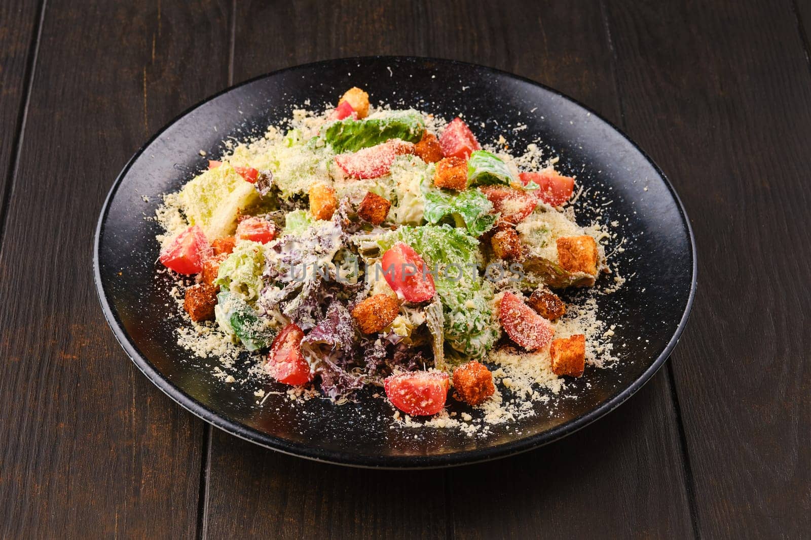 Caesar salad with fresh vegetables, croutons and grated cheese
