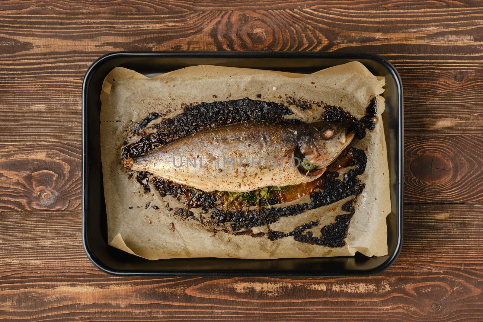 Baked sea yellow tailed mackerel in baking tray, top view