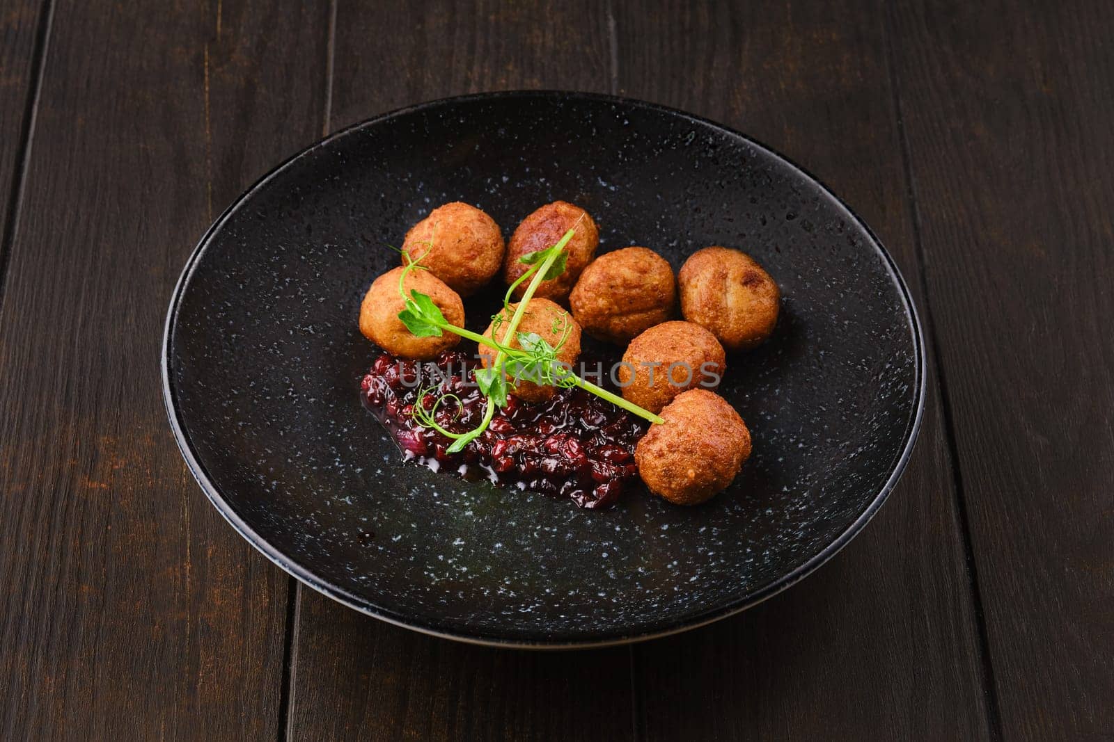 Plate with traditional scandinavian meatballs with cranberry sauce