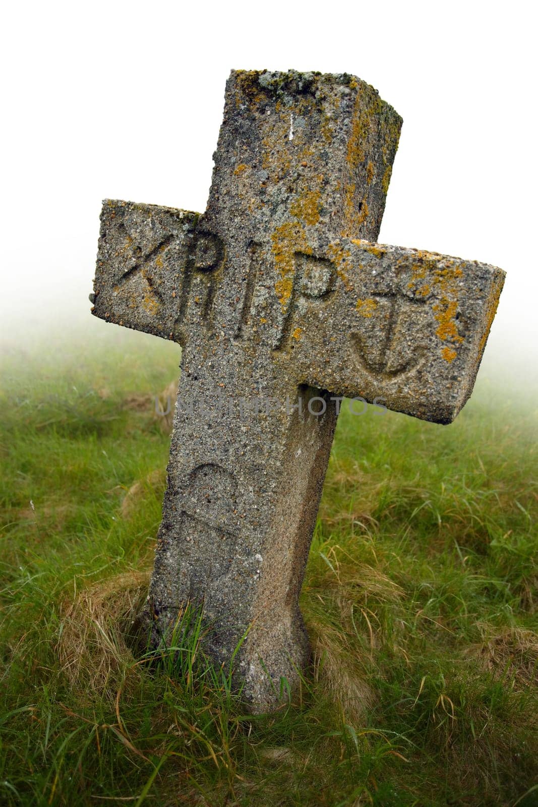 Gravestone with the initials RIP carved into it.  Ancient gravesite in South Uist, Scotland.