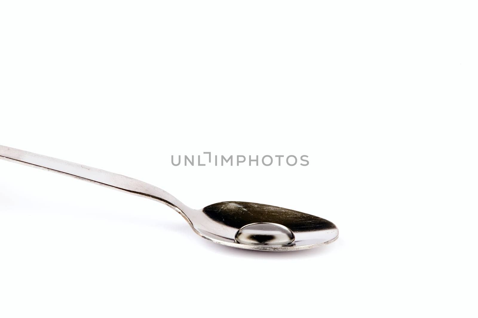 a spoon with drop, isolated on white background