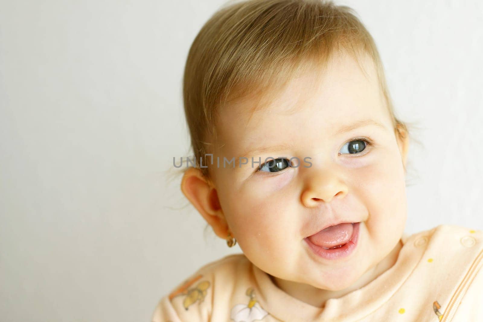 Small baby laughing on the bright background