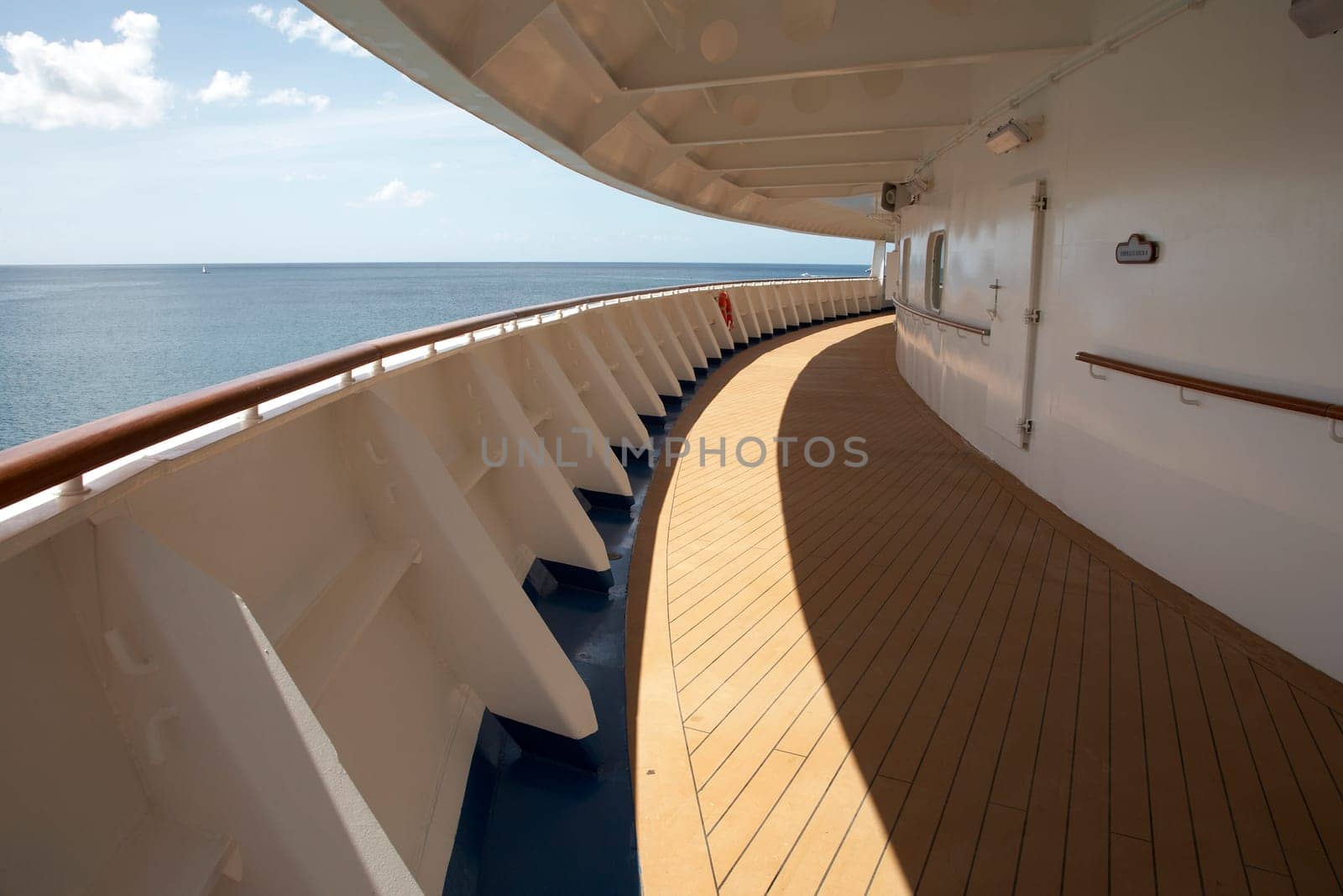 view of an empty cruise ship deck sweeping around the bow of the ship