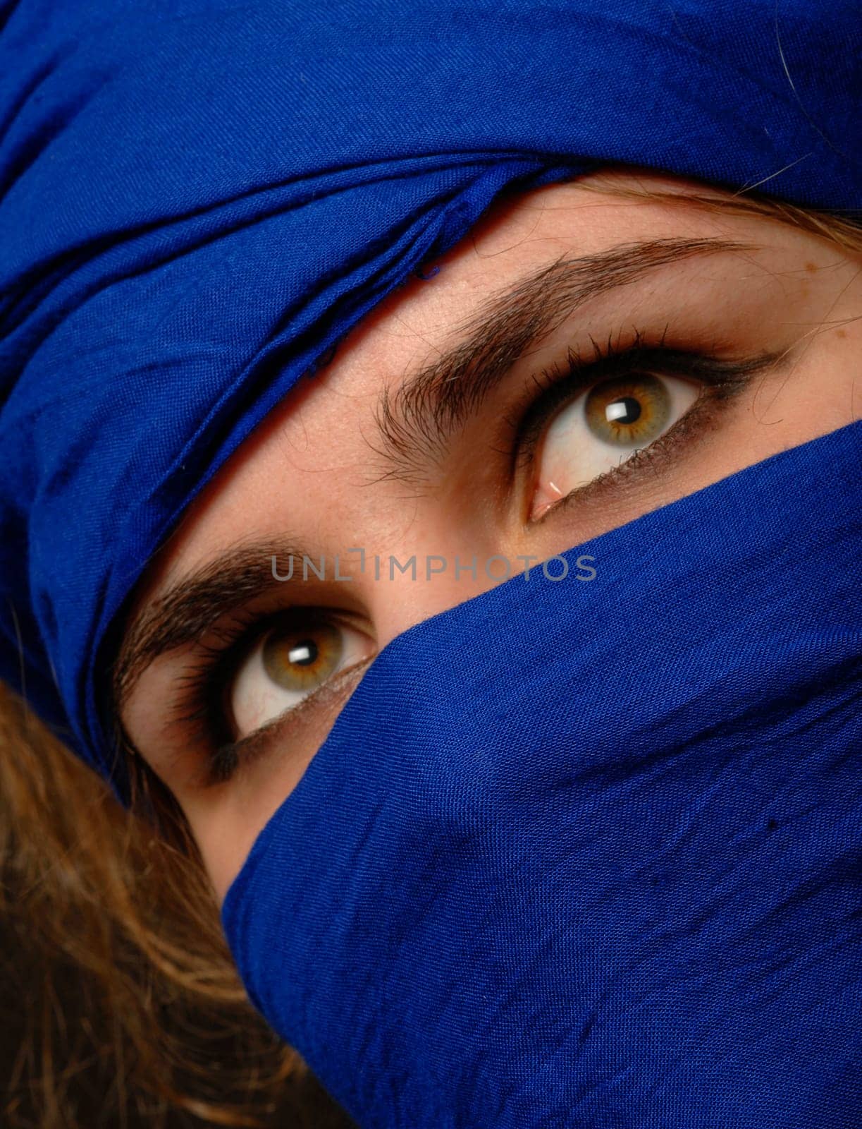 beautiful eyes surrounded by blue scarf
