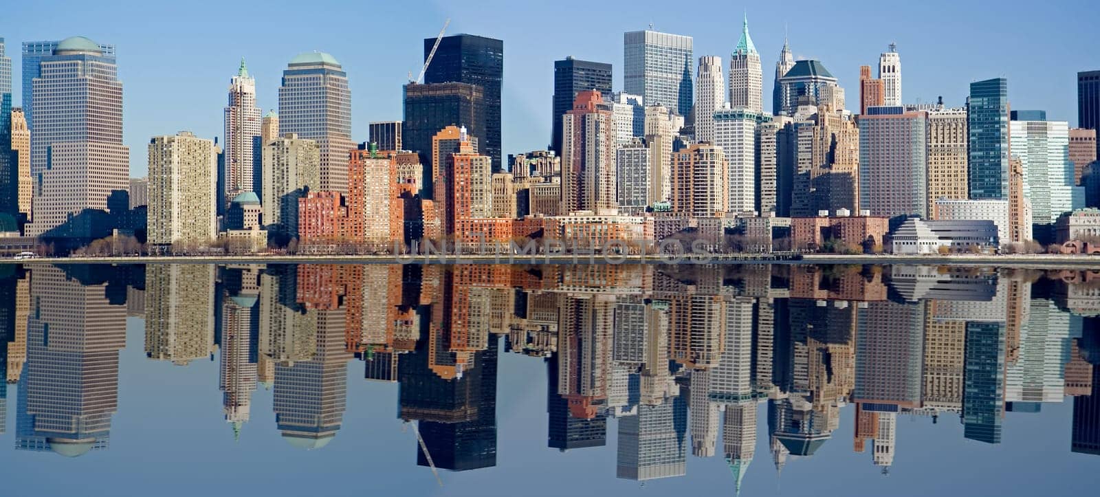 Panorama of Manhattan skyline with water reflection